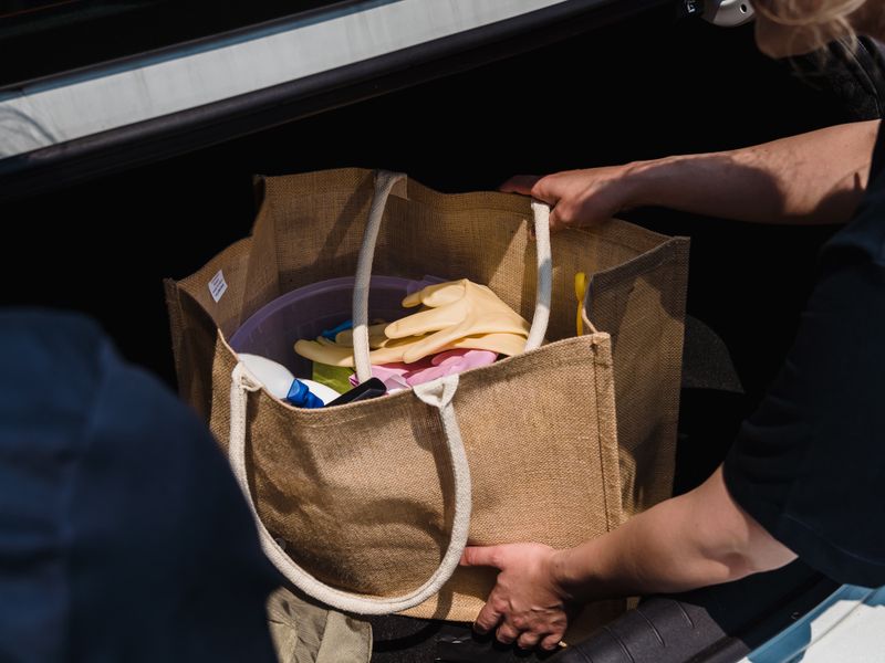 Shopping bag being placed in a car boot