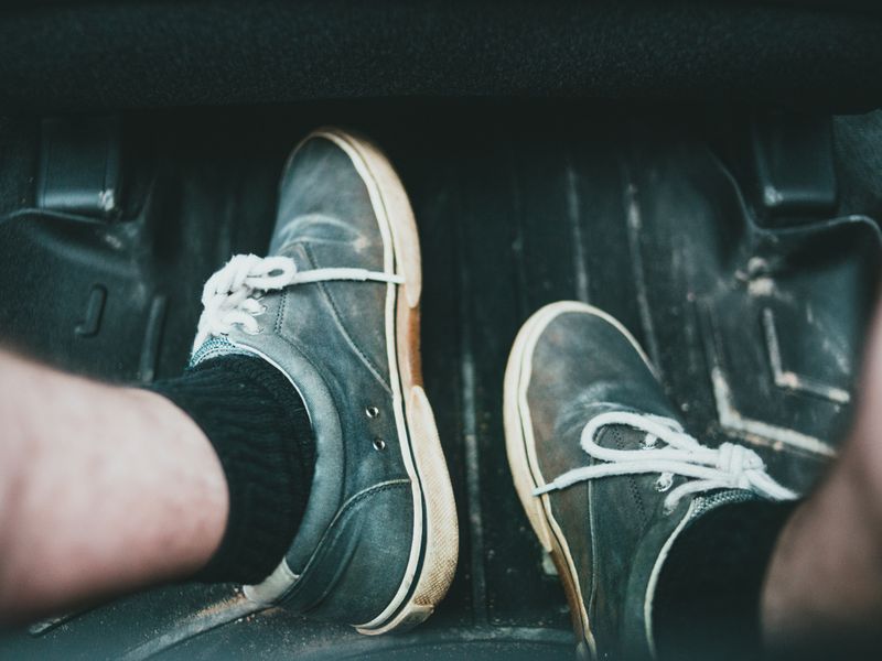 Shoes resting on a rubber car floor mat