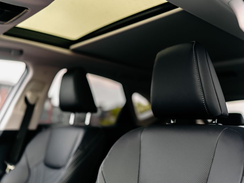 Car interior under a panoramic glass roof